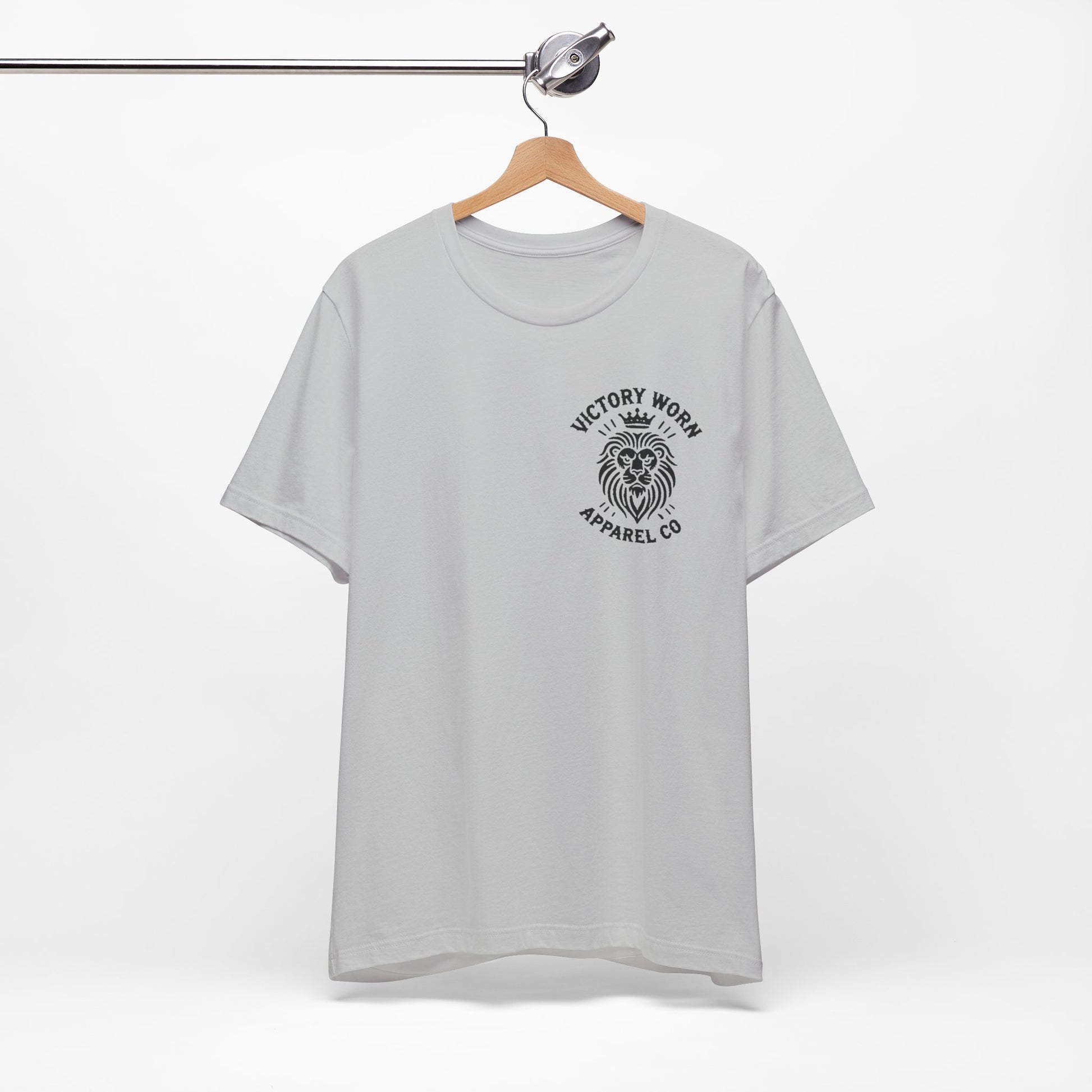 Death Defeated' T-shirt in Solid Athletic Grey, featuring the Victory Worn Apparel Co. lion logo on the front, hanging on a wooden hanger against a clean white background.